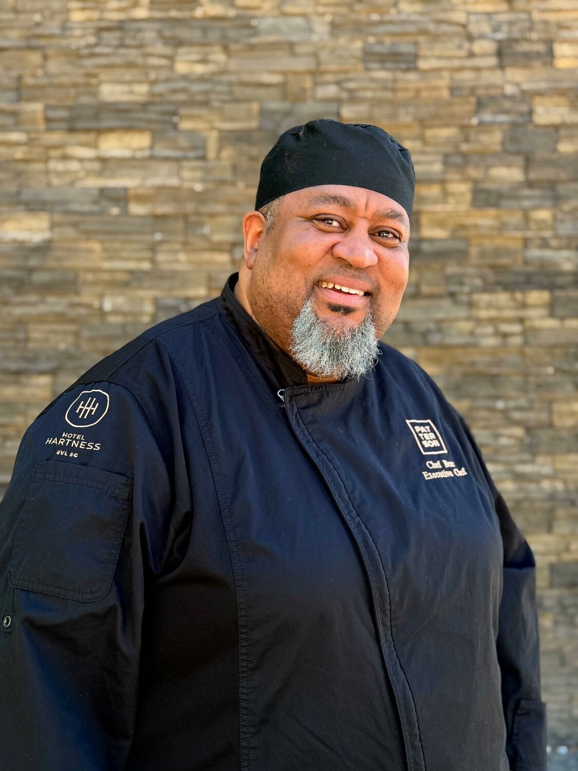Chef Bear, Curtis Hillard, smiling in his chef whites